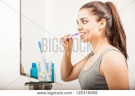 Pretty Girl Brushing Her Teeth In The Morning