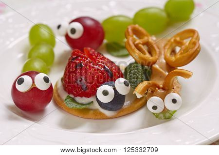 Funny beetles from grapes, berries and pretzels