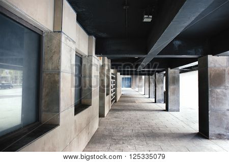 urban stone hallway with grey columns daylight