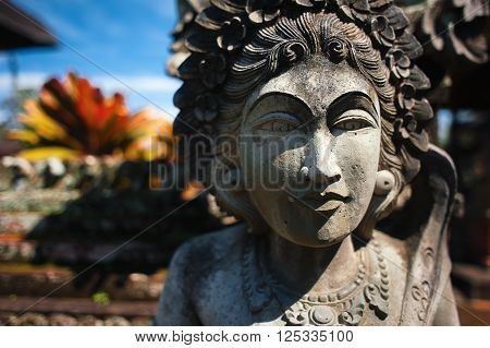 traditional balinese asian hindu stone woman monument in buddhism style