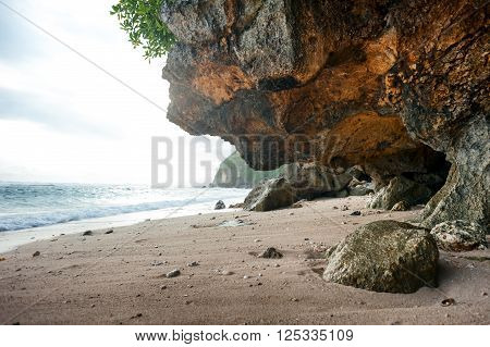 landscape with sea, sandy beach and rock