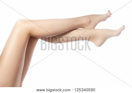Beautiful female legs after depilation. Healthcare, foot care, rutine treatment. Spa and epilation. Sexy shape of woman's body. Part of female body. Feet with perfect clean smooth skin and pedicure.