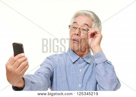 portrait of senior Japanese man with presbyopia