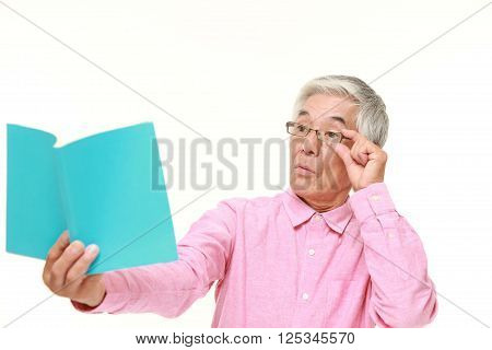 portrait of senior Japanese man with presbyopia