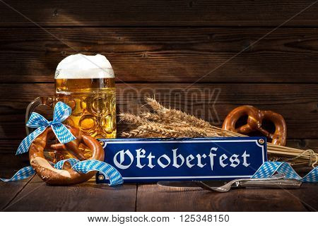 Original bavarian pretzels with beer stein on wooden board. Oktoberfest background