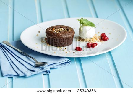 Chocolate cake with ice-cream on blue backgraund