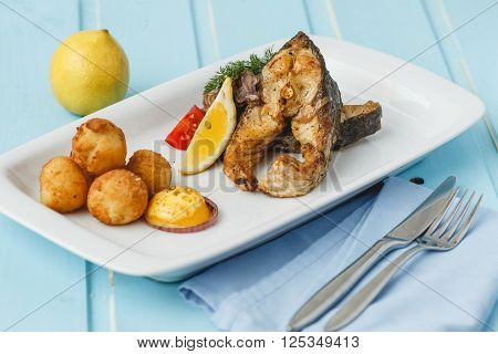 Grilled fish with fried cheese and vegetable