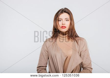 Portrait of confident attractive young businesswoman standing over white background