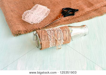 Empty vase, scissors, burlap, lace. Set for handmade vase