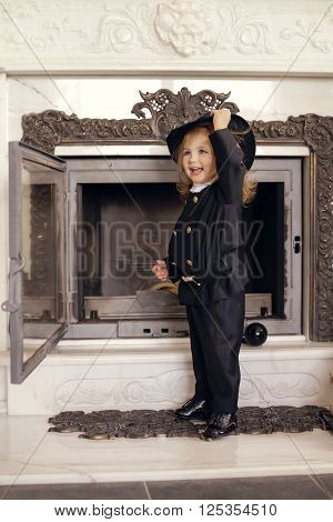 Girl as a chimney sweep against fireplace. Lucky New Year's Eve and New Year.