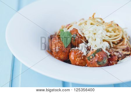 Meatballs with tomato sauce on blue wood background
