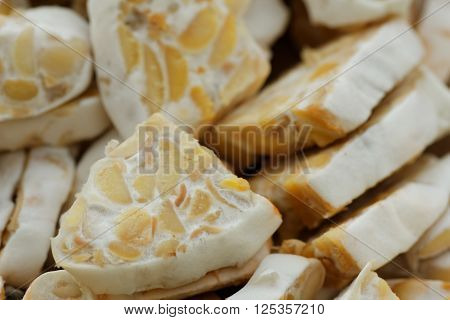 Sliced fresh raw tempeh. Close up showing texture of tempeh. Tempeh is made from soya bean and popular in some part of Asia.