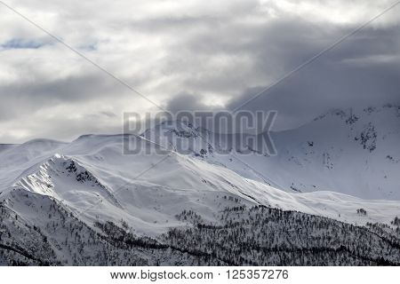 Evening Sunlight Mountains And Gray Cloudy Sky