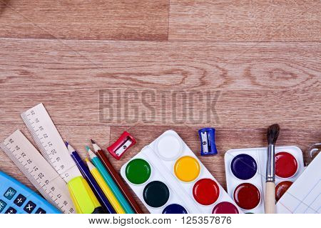 Paints, brushes, colored pencils and album - drawing tools on a desk