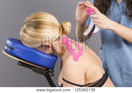 Physiotherapist /doctor Applying Cervical Kinesiotape.
