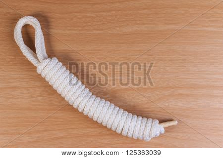 Orderliness White Scout Rope On Wooden Table.