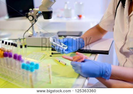 Measure child glucose level blood test diabetes little girl using glucometer selective focus