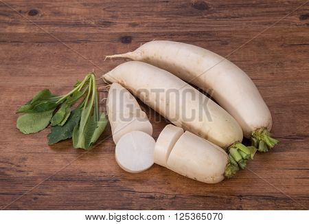 Daikon radish on the wood background