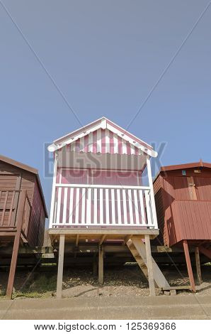 Three beach huts in a row, Frinton-on-sea Essex England UK.