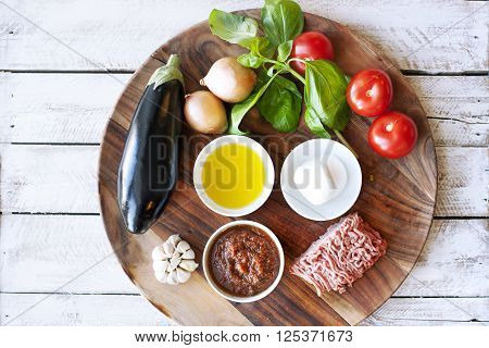Ingridients for cooking Parmigiana di melanzane: baked eggplant - italy, sicily cousine. On the wooden table.