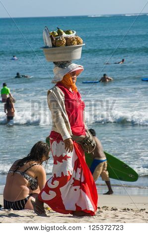KUTA,INDONESIA - JULY 29 : woman sells fruits in Kuta beach on the 29th of july 2009 in Kuta Bali