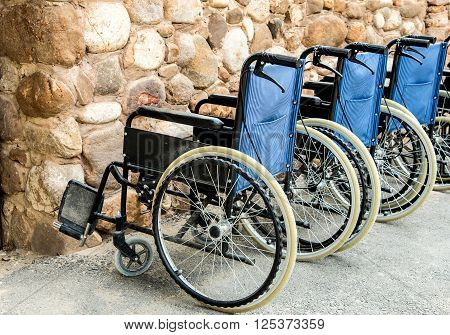 Wheelchairs Wheel chairs parked cars lineSide shooting.