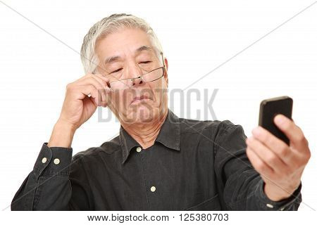 portrait of senior Japanese man with presbyopia