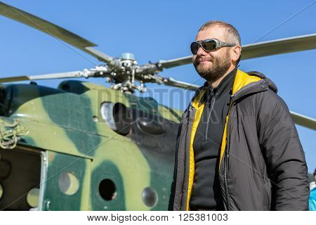 Portrait of Alpine Climber Preparing for Boarding to Helicopter for Flight to High Altitude Mountain Camp in Remote inaccessible area