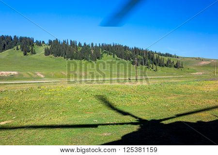 Rural Area of Green Grassy Kirghiz Steppe and Shadow of Helicopter Rotor Screw