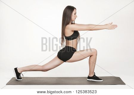 Portrait of young attractive woman doing exercises. Brunette with fit body on yoga mat. Healthy lifestyle and sports concept. Series of exercise poses.