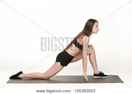 Portrait of young attractive woman doing exercises. Brunette with fit body on yoga mat. Healthy lifestyle and sports concept. Series of exercise poses.
