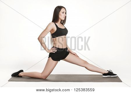 Portrait of young attractive woman doing exercises. Brunette with fit body on yoga mat. Healthy lifestyle and sports concept. Series of exercise poses.