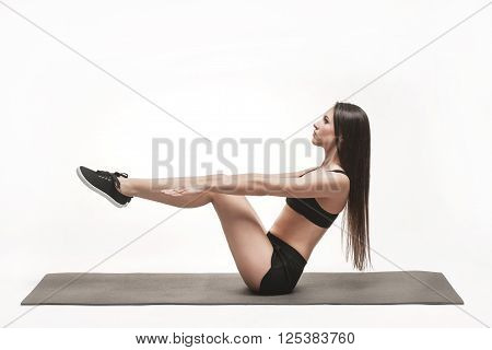 Portrait of young attractive woman doing exercises. Brunette with fit body on yoga mat. Healthy lifestyle and sports concept. Series of exercise poses.