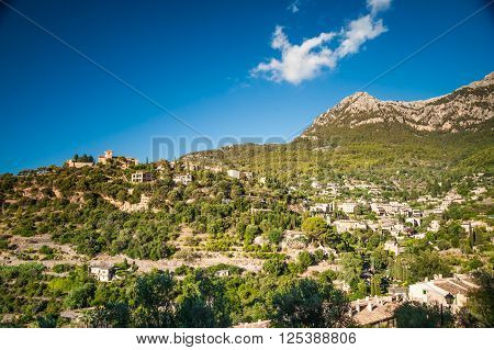 Beautiful view of a small mountain village Deia in Mallorca, Spain. Houses built on hills in Deia mountain village in Majorca island, Spain.