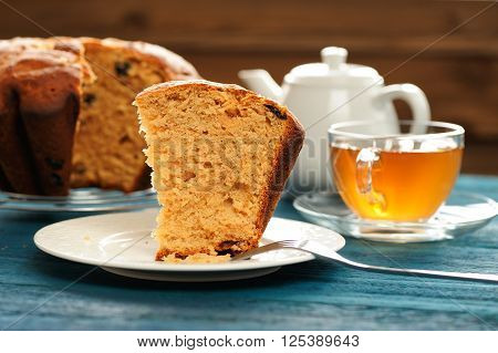Gugelhupf cut with green tea and teaware on wooden background closeup
** Note: Shallow depth of field
