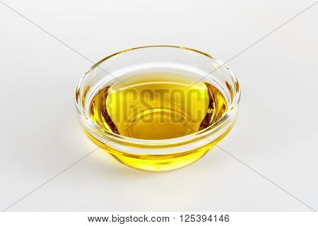olive oil in glass plate closeup jn white background