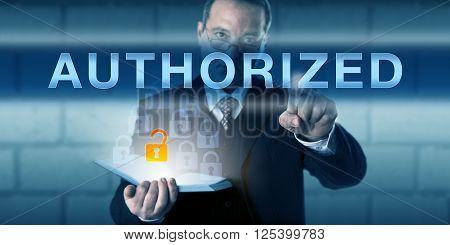 Business person is touching AUTHORIZED on a virtual interactive screen. Information technology and information security concept for access control policy and rules guarding computer resource usage.