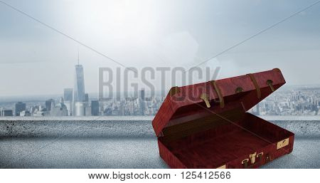 Composite image of opened suitcase against cityscape