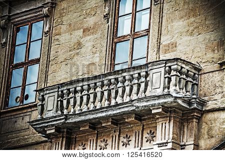 typical Tuscan balcony in a yellow building Italy