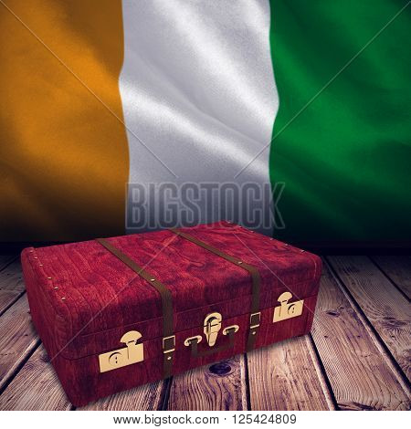Wooden suitcase against ivory coast national flag