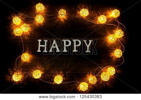 Happy -  plain paper letters on woodden background