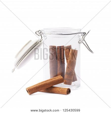 Glass jar filled with the cinnamon sticks isolated over the white background