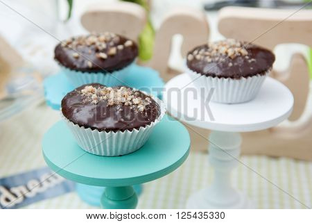 three spongecake or muffin with chocolate sauce