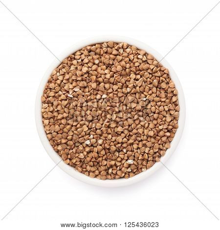 White ceramic bowl full of the buckwheat seeds isolated over the white background, top view above foreshortening