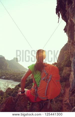 successful woman hiker enjoy the view on mountain top