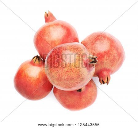 Pile of multiple pomegranate Punica granatum fruits isolated over the white background