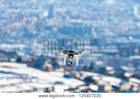 Ulan-Ude, Russia - March 5, 2016: Hovering drone that takes pictures of city sights