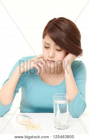 studio shot of young Japanese woman suffers from melancholy?