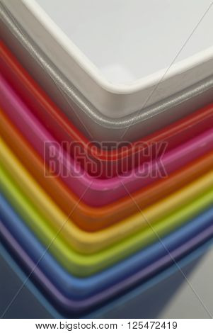 Group of colorful plastic containers in stack