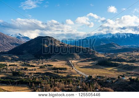 Epic mountain valley landscape. Aerial scenic valley view from Crown Range road Queenstown New Zealand. Mountain road to Queenstown. Beautiful mountain landscape